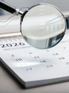 Calendar page for 2026 with magnifying glass, symbolising future Social Security COLA adjustments