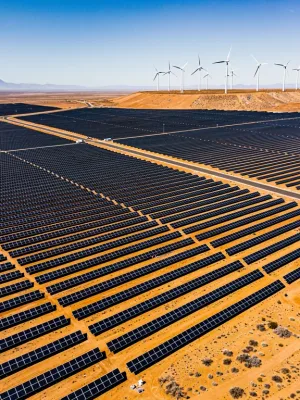 Expansive solar farm with wind turbines, symbolising US renewable energy commitment.