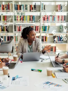 Graduate students discussing funding options in a university library.