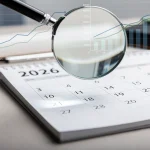 Calendar page for 2026 with magnifying glass, symbolising future Social Security COLA adjustments